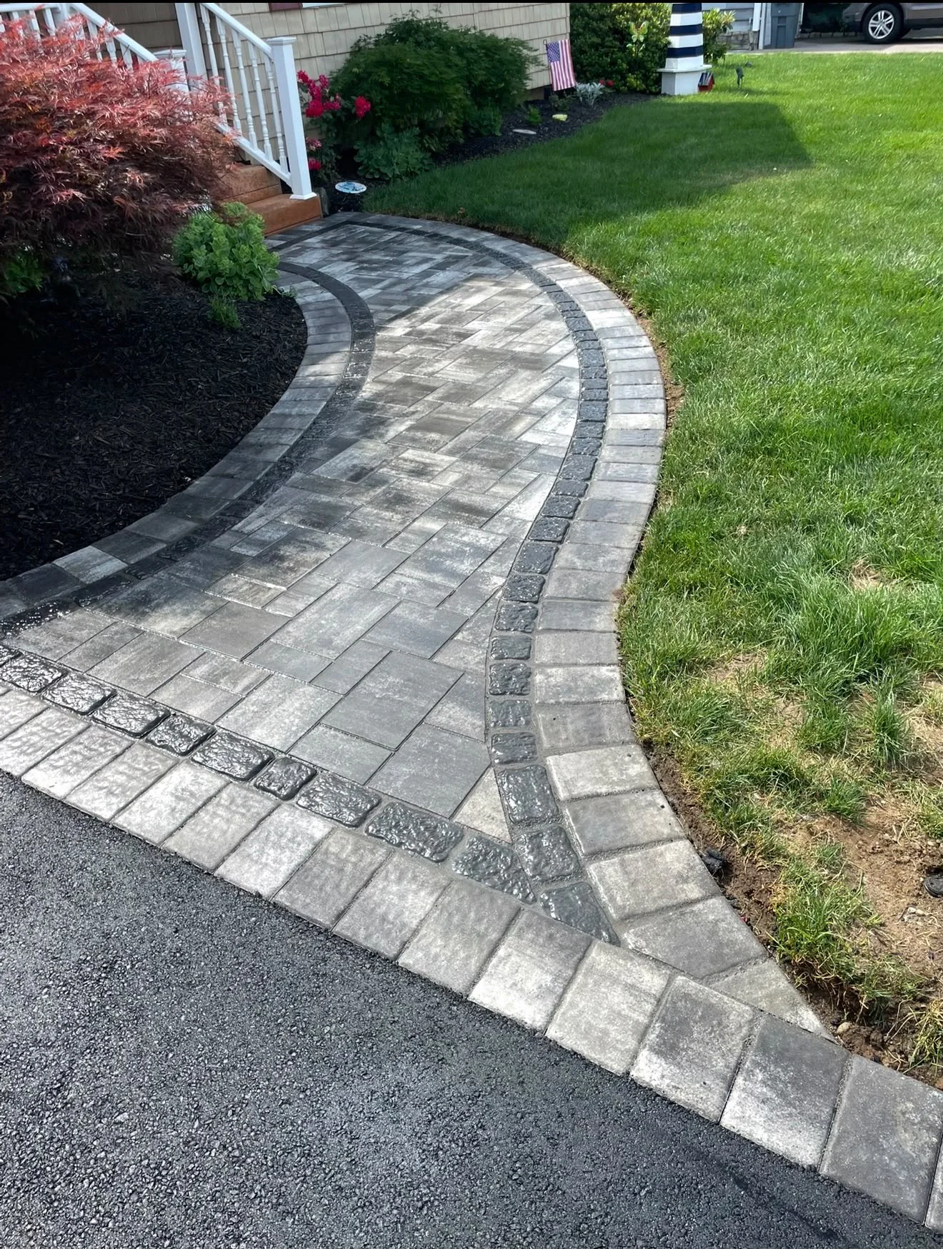 Custom curved interlocking paver walkway with double charcoal border leading to front porch steps in Stamford CT