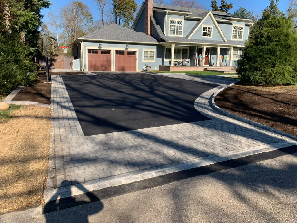 Asphalt driveway installation with interlocking paver apron and Belgian block cobblestone border in Stamford CT