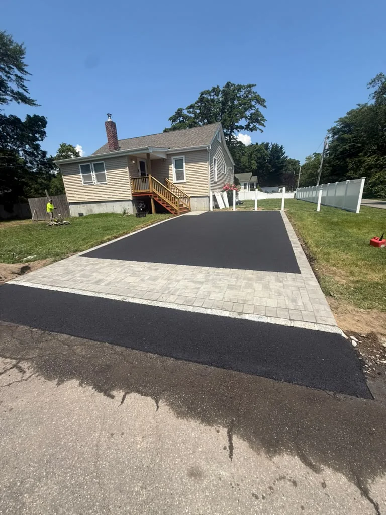 Residential asphalt driveway with paver apron and Belgian block granite curbing in Stamford CT